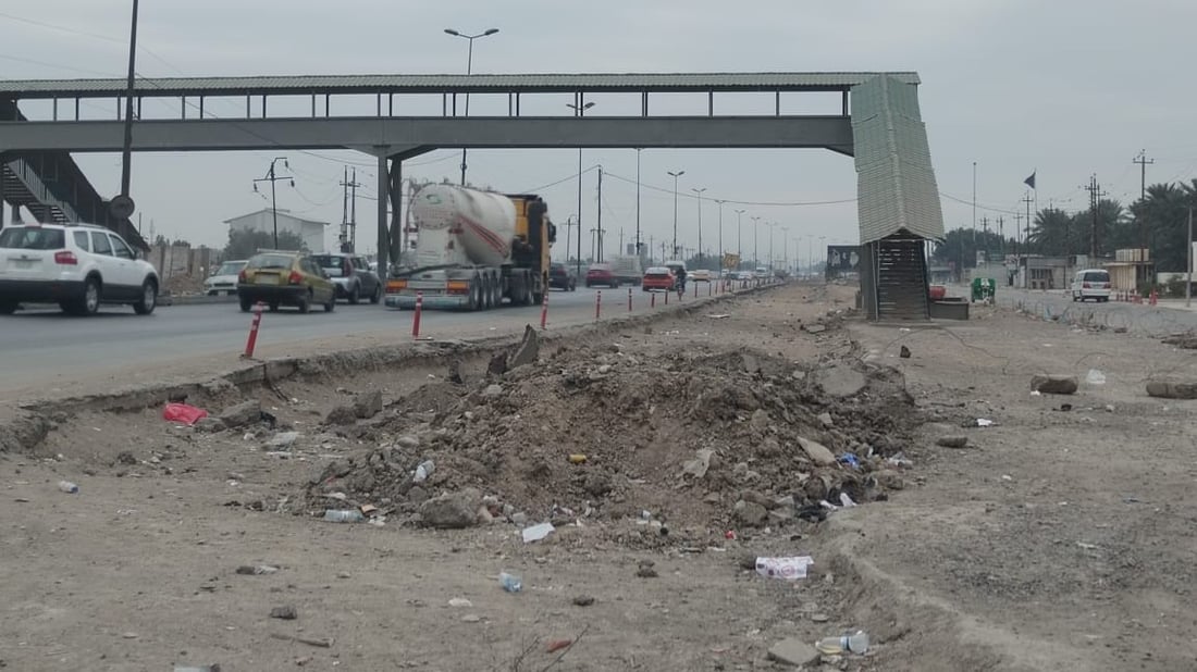 العمل متوقف بتأهيل مدخل بغداد الجنوبي منذ 11 شهراً.. تعليق من الأمانة (صور)
