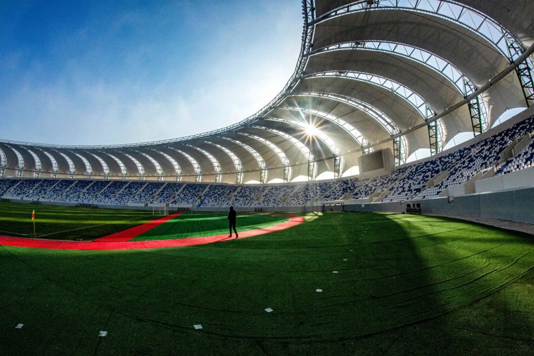 A man walks near the pitch at the New Minaa Olympic Stadium, built to accomodate 30,000 spectators, in Iraq's southern city of Basra on December 26, 2022, ahead of its inauguration in a friendly exhibition match between Iraqi al-Minaa club and Kuwait SC. (Photo by Hussein FALEH / AFP) (Photo by HUSSEIN FALEH/AFP via Getty Images)