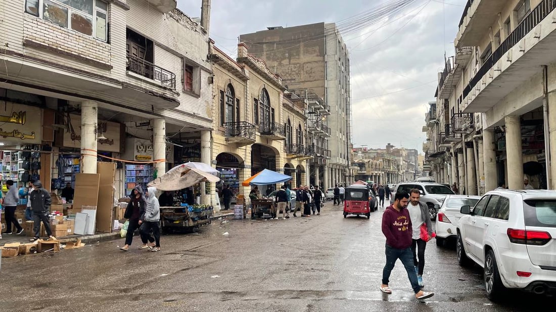 صور من حياة الشارع في بغداد: اليوم الأول لارتداء “القمصلة” وحمل مظلات المطر