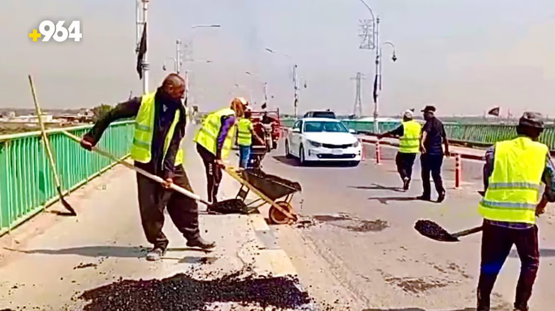 Youth volunteers restore concrete bridge and road in Basra