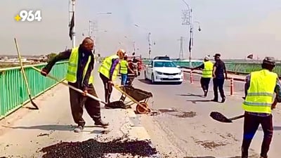 Youth volunteers restore concrete bridge and road in Basra