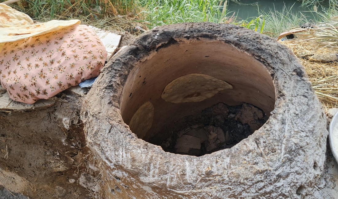 Diwaniyah women keep tradition alive with clay ovens for bread baking