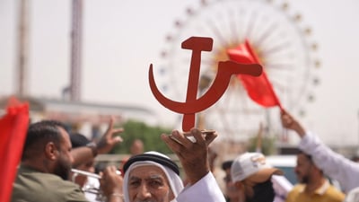 Under red banners, workers and activists rally in Basra for labor rights