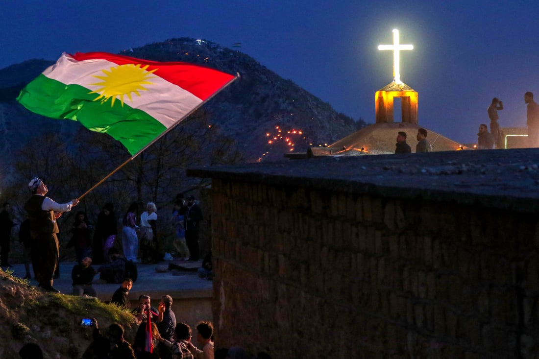 An Iraqi Kurdish man waves a flag of Kurdistan during the Nowruz New Year festival in the town of Akre (Photo by Safin HAMID/AFP)