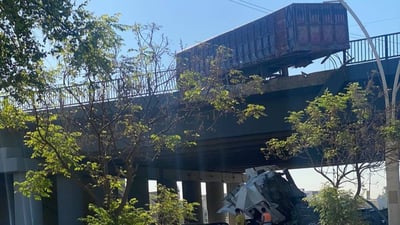 Truck crash in Mosul leaves driver critically injured, trailer hanging off bridge