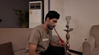 Najaf shisha smokers check the charcoal as Hormuz crisis lifts prices