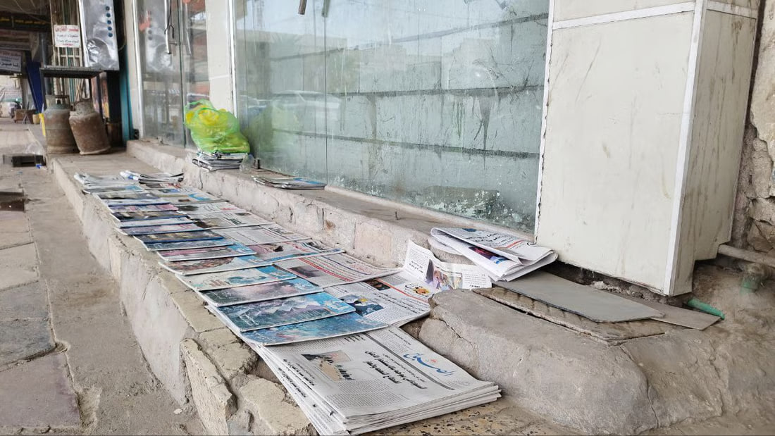 A newspaper vendor preserves tradition in Hillah amid changing reading habits