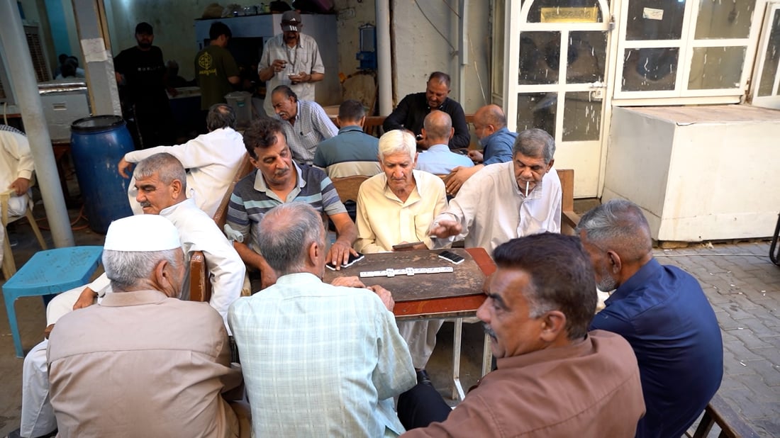 A narrow side street in Kut is a daily hub for tea and dominoes