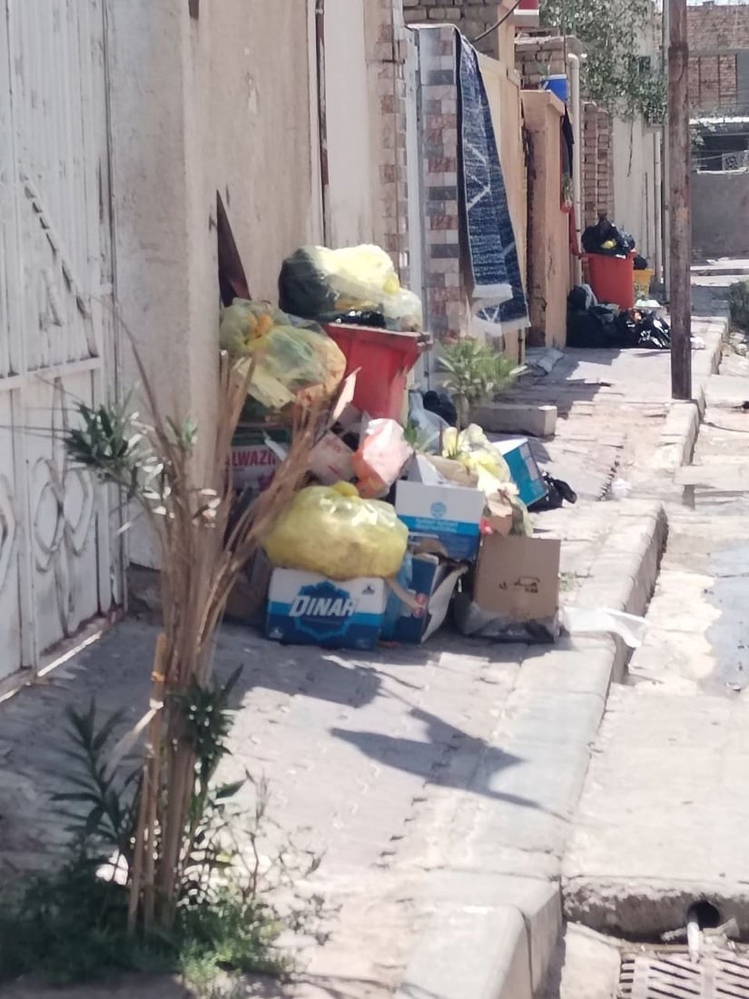 Garbage piles up in Al-Qala’a Al-Salih town as sanitation workers strike over unpaid wages