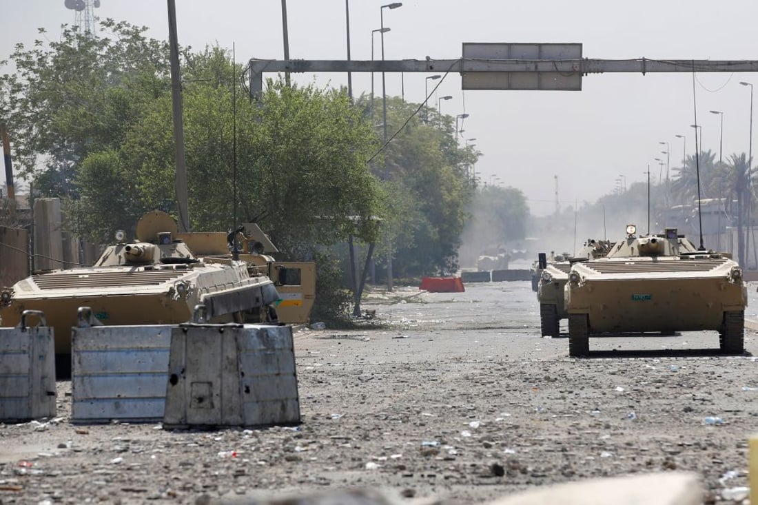 Iraqi security armoured vehicles are pictured during clashes with Saraya al-Salam (Peace Brigade), the military wing affiliated with Shiite cleric Moqtada al-Sadr, in Baghdad's Green Zone on August 30, 2022. - Fighting between rival Iraqi forces resumed in Baghdad, where 23 supporters of Shiite leader Moqtada Sadr have been shot dead since Monday, according to the latest toll by medics. Clashes between Sadr's supporters and the army and men of the Hashed al-Shaabi, former paramilitaries integrated into the Iraqi forces, had calmed down overnight but resumed again on this morning. (Photo by Ahmad Al-rubaye / AFP) (Photo by AHMAD AL-RUBAYE/AFP via Getty Images)