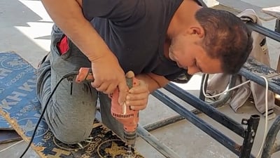 Suq Al-Shuyukh blacksmith repairs school desks for free