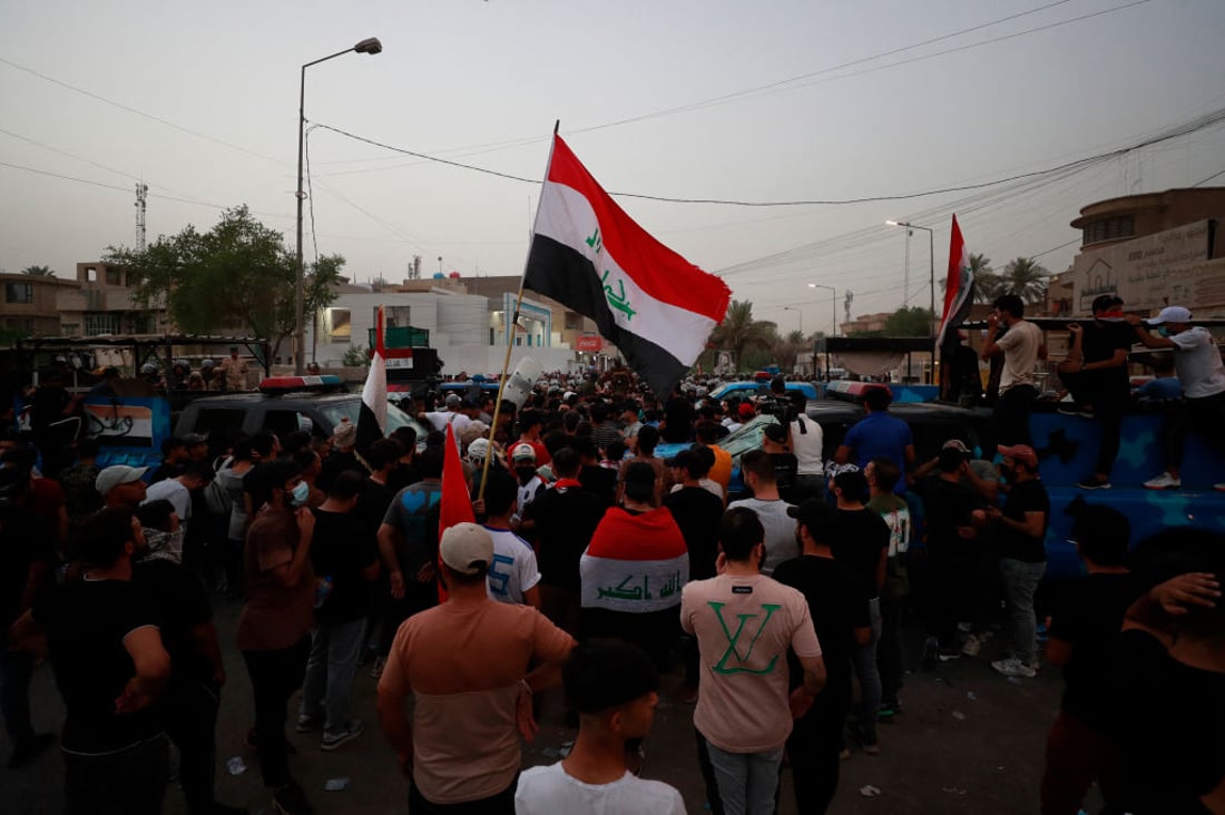 Iraqis chant slogans demanding the expulsion of the Turkish ambassador, outside the Turkish visa office in Baghdad on July 21, 2022, following a deadly artillery bombardment of a Kurdish hill village in northern Iraq. - An angry and grieving Iraq today buried nine holidaymakers -- including a newlywed -- killed in the attack. The government has blamed neighbouring Turkey, which denied its troops were responsible and instead accused rebels of the outlawed Kurdistan Workers Party (PKK). (Photo by AHMAD AL-RUBAYE / AFP) (Photo by AHMAD AL-RUBAYE/AFP via Getty Images)