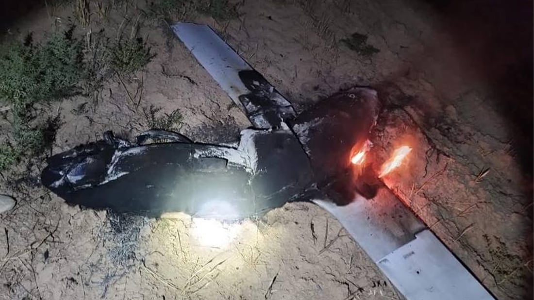 The burned remains of a suspected explosive drone lie on the ground near Erbil International Airport following a pre-dawn detonation on Monday.
