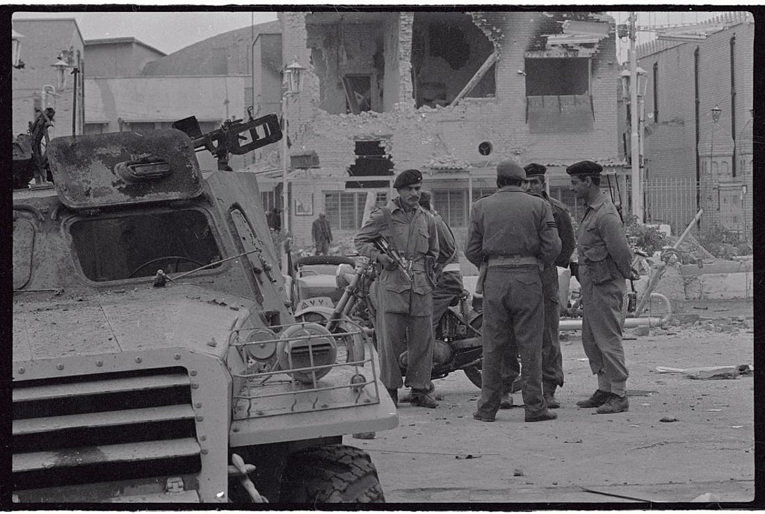 (Original Caption) Cradling Sten guns under their arms, beretted Iraqi soldiers guard gaping wreckage of the Defense Ministry, in one of the first pictures out of Baghdad since the February 8th revolution. Overthrown President Abdel Karim Kassem, executed February 9th, and other leaders of the old government mad a last stand in the ministry for hours February 8th against rebel air and ground attacks.