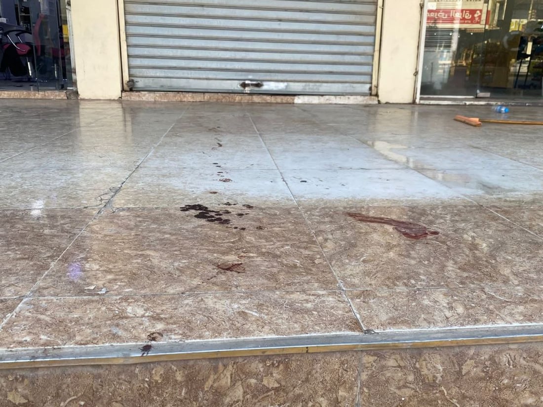 Bloodstains outside a shuttered shop in Kirkuk’s Wasiti neighborhood after an armed robbery left an exchange outlet owner injured