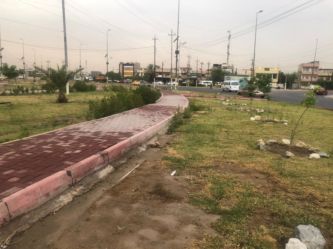 حديقة بدل القمامة عند مدخل حي الجهاد في بغداد.. أعمال التأهيل انتهت (صور)