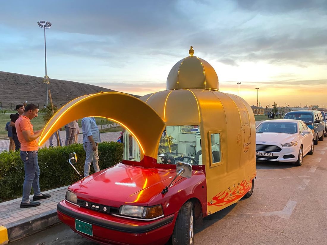 صور: عمر الشريفي حوّل “مازدا” حمراء إلى دلّة تجوب شوارع الموصل وتكرم المارة