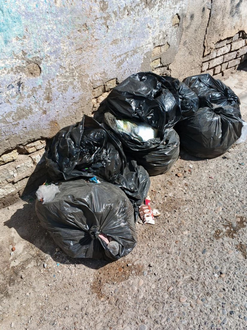 Garbage piles up in Al-Qala’a Al-Salih town as sanitation workers strike over unpaid wages