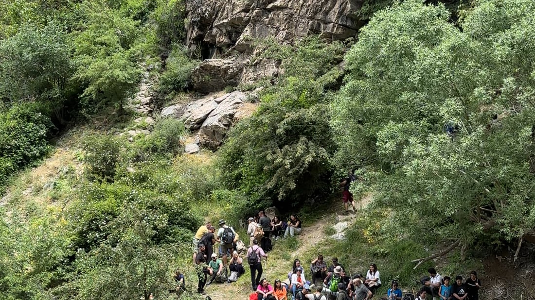 A local documents and guides tourists through Balakayati’s natural terrain
