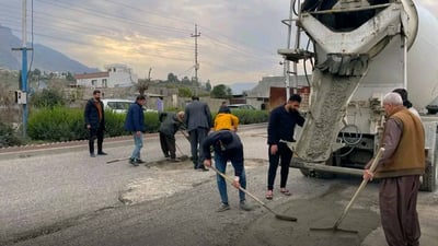کۆمپانیایەک لەبری حکومەت چاڵ و چۆڵی شەقامێک پڕ دەکاتەوە